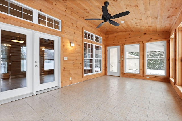 unfurnished sunroom featuring ceiling fan, wooden ceiling, and vaulted ceiling