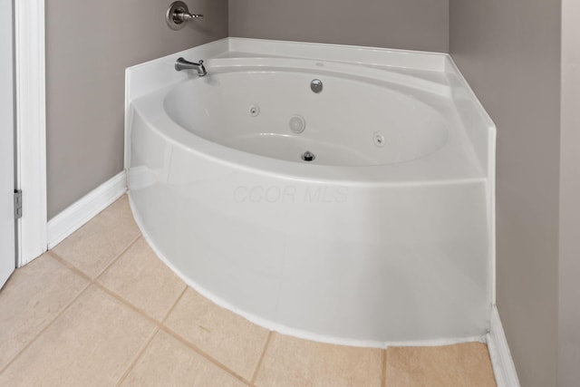 bathroom featuring tile patterned flooring and a tub to relax in