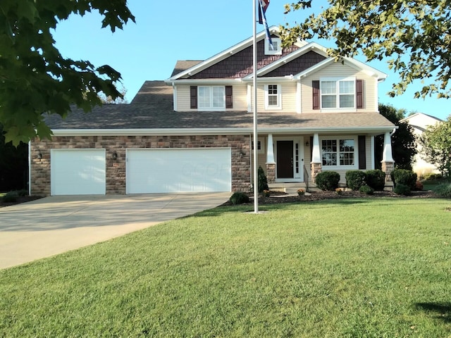 craftsman house with a garage and a front lawn