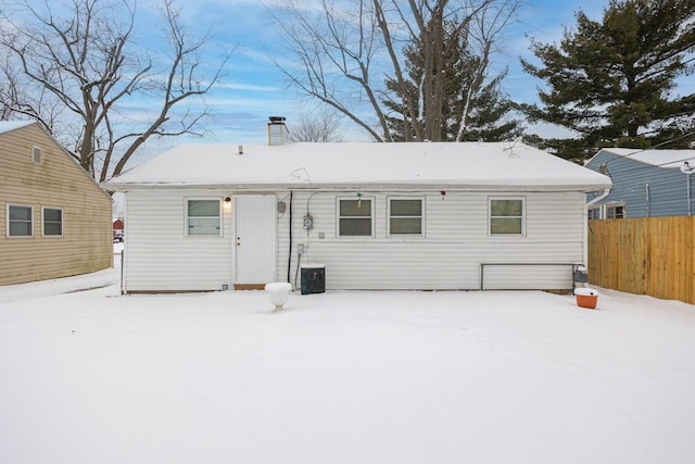 view of snow covered rear of property