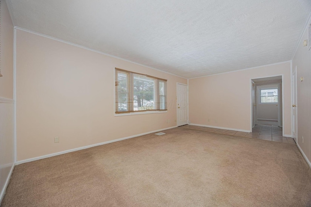 unfurnished room featuring light carpet, crown molding, and a textured ceiling