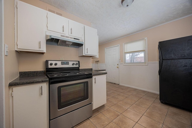 kitchen with white cabinets, black refrigerator, stainless steel electric range oven, a textured ceiling, and light tile patterned flooring