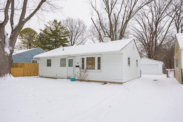 view of front of home with a garage and an outdoor structure