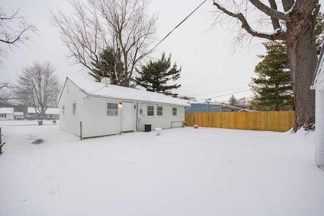 view of snow covered back of property