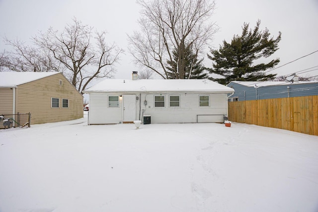 view of snow covered rear of property