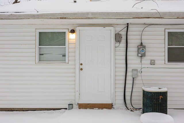 view of exterior entry with central air condition unit