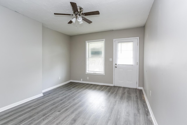 empty room featuring hardwood / wood-style flooring and ceiling fan