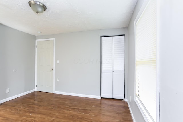 unfurnished bedroom featuring dark wood-type flooring