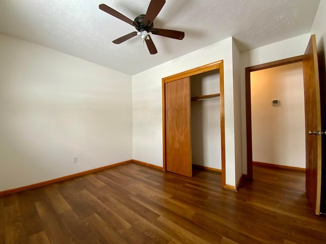 unfurnished bedroom featuring a closet, ceiling fan, and dark hardwood / wood-style floors