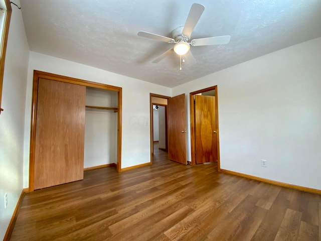 unfurnished bedroom featuring hardwood / wood-style flooring, ceiling fan, and a closet