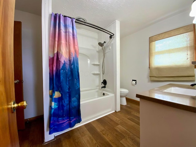 full bathroom with shower / bath combination with curtain, a textured ceiling, toilet, vanity, and hardwood / wood-style flooring