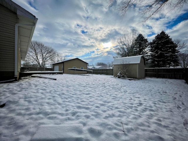 snowy yard with a storage unit