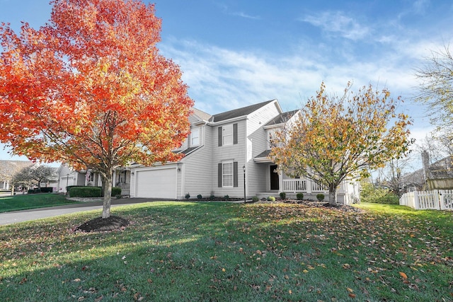 view of front of property with a porch, a front lawn, and a garage