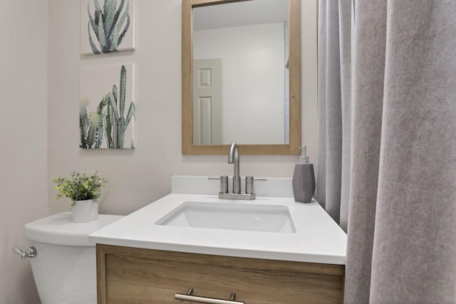 bathroom featuring vanity and toilet