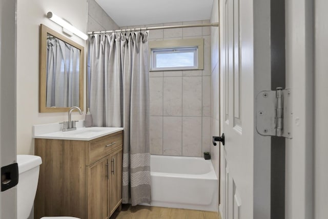 full bathroom featuring hardwood / wood-style flooring, vanity, toilet, and shower / bathtub combination with curtain