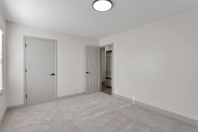 unfurnished bedroom with light colored carpet