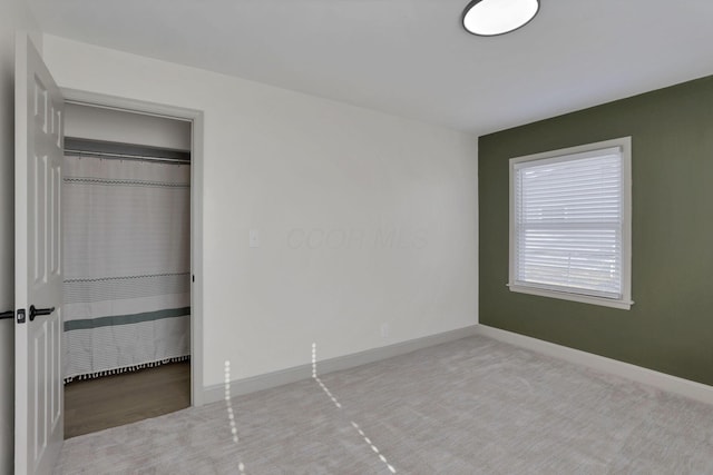 unfurnished bedroom with carpet flooring and a closet