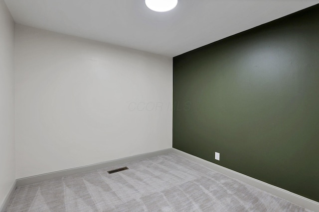 spare room featuring light colored carpet