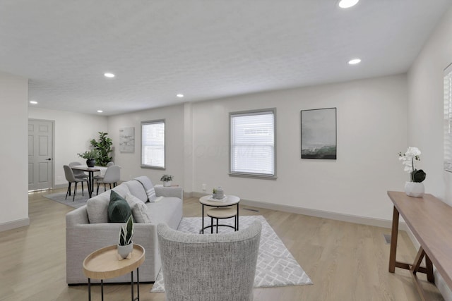 living room with plenty of natural light and light wood-type flooring