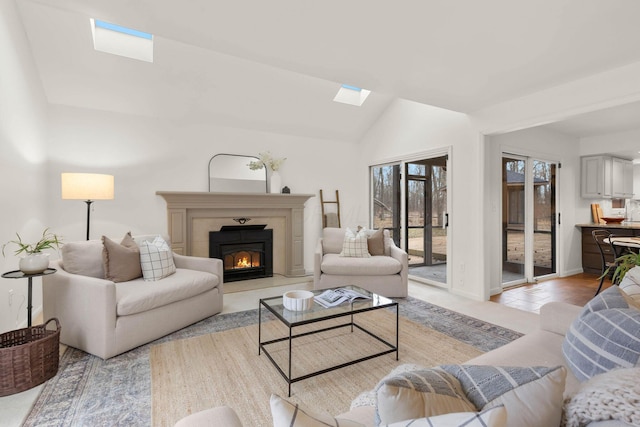 tiled living room featuring lofted ceiling with skylight and a premium fireplace