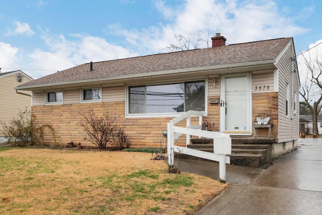 ranch-style house with a front lawn