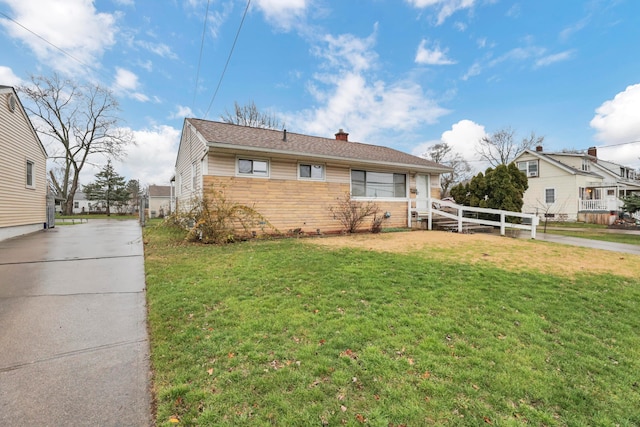 bungalow-style home featuring a front lawn