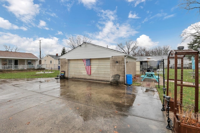 exterior space with an outbuilding, a garage, and a lawn