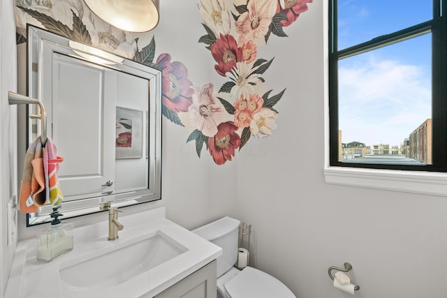 bathroom featuring vanity, toilet, and a wealth of natural light