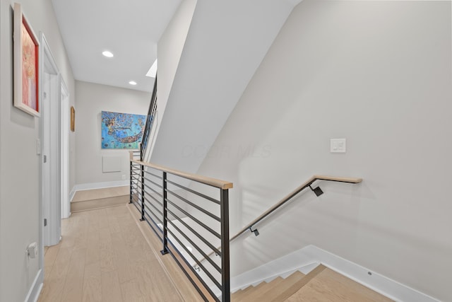 stairs featuring hardwood / wood-style floors