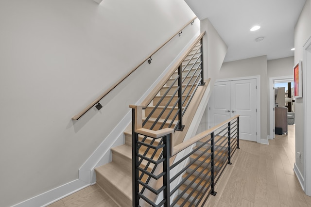 stairway with hardwood / wood-style flooring