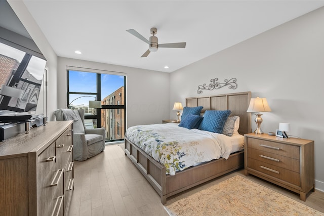 bedroom with ceiling fan and light hardwood / wood-style floors