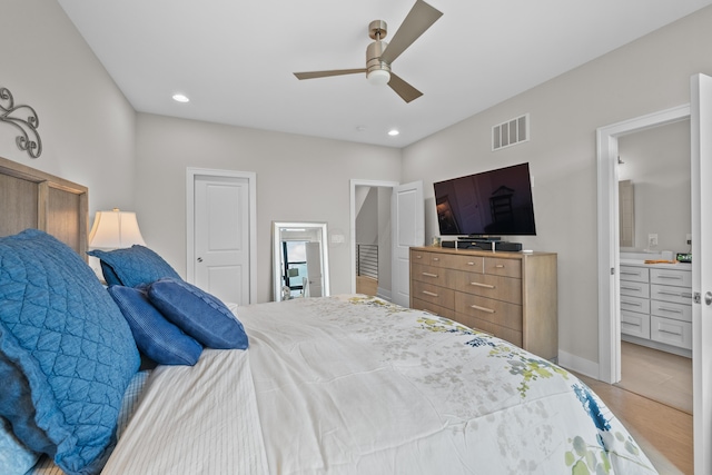 bedroom featuring ensuite bathroom, hardwood / wood-style floors, and ceiling fan