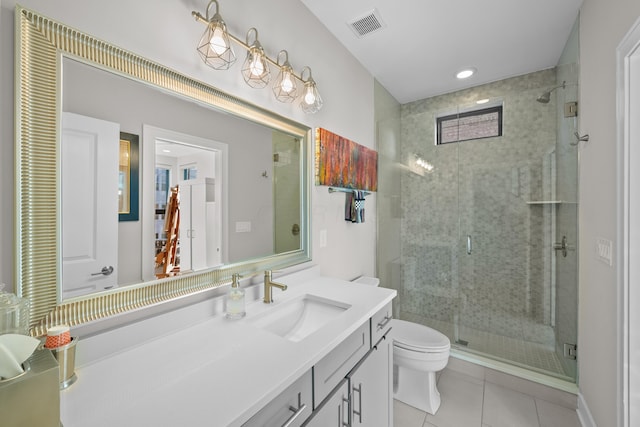 bathroom with toilet, tile patterned flooring, vanity, and walk in shower