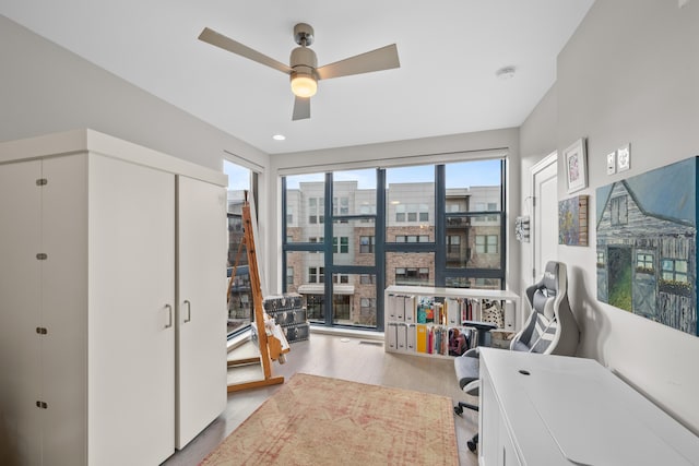 office area featuring light hardwood / wood-style flooring and ceiling fan