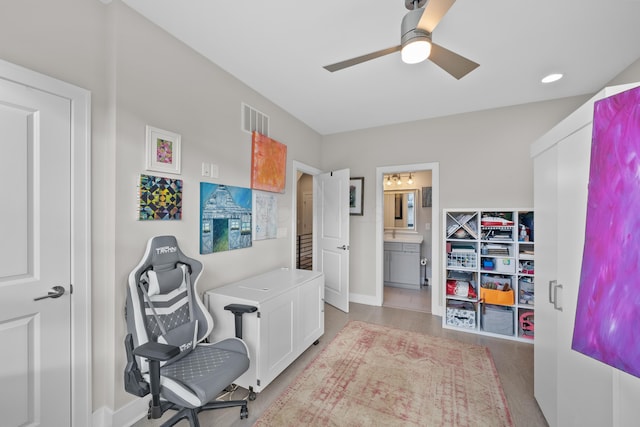 office featuring light hardwood / wood-style floors and ceiling fan