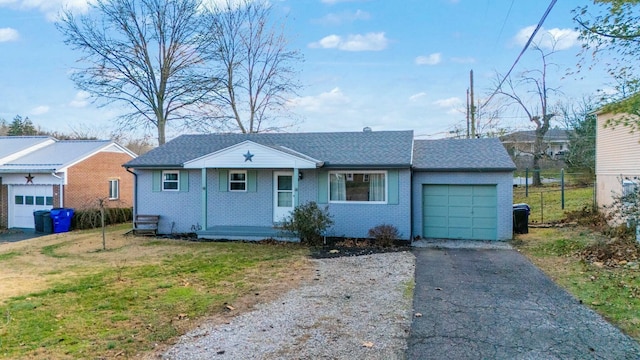 ranch-style home with a garage and a front lawn