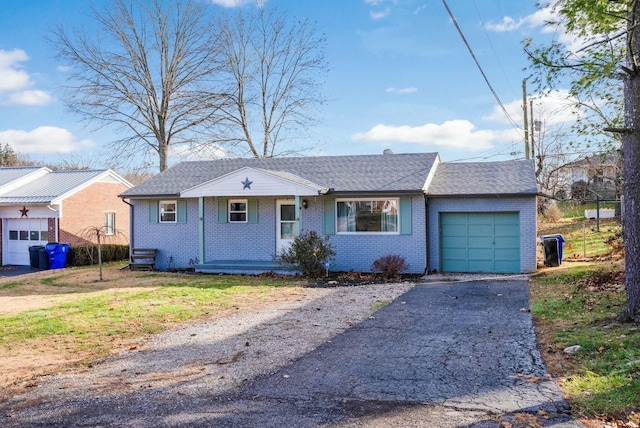 view of front of property featuring a front yard and a garage