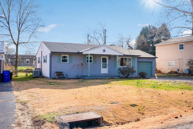 view of front of property featuring a garage and central air condition unit