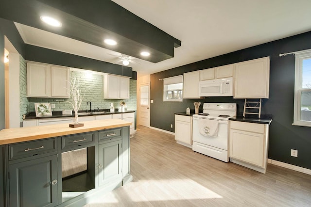 kitchen with white appliances, butcher block countertops, white cabinetry, and gray cabinetry