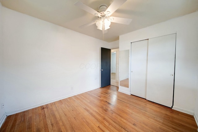 unfurnished bedroom featuring a closet, light hardwood / wood-style floors, and ceiling fan