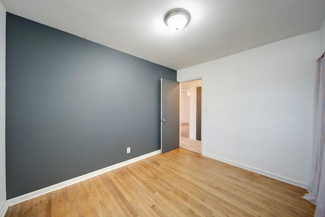 spare room with light hardwood / wood-style flooring