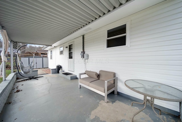 view of patio featuring a shed