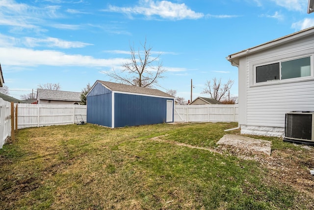 view of yard featuring central air condition unit and a storage unit