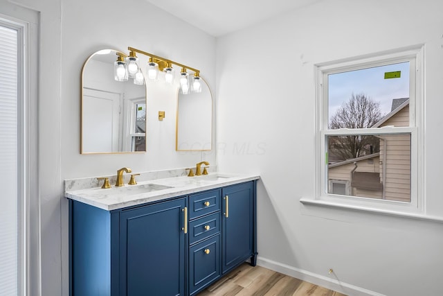 bathroom with vanity, hardwood / wood-style flooring, and a wealth of natural light