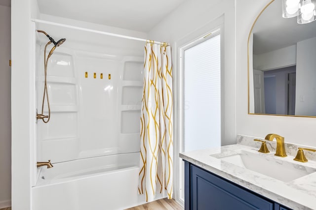 bathroom featuring vanity and shower / bath combination with curtain