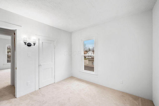 unfurnished bedroom featuring light colored carpet