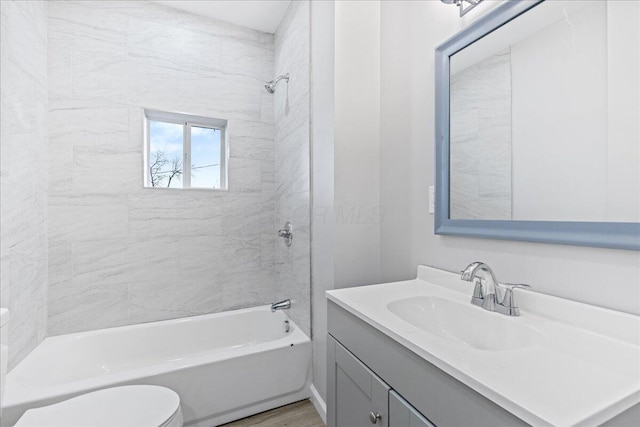 full bathroom with vanity, toilet, and tiled shower / bath