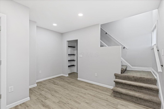 staircase featuring hardwood / wood-style floors