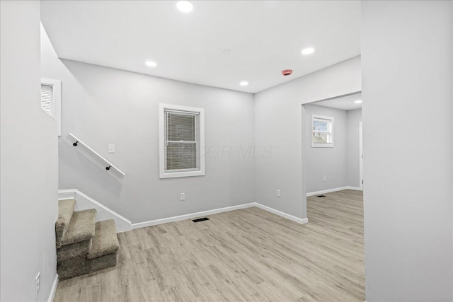 spare room with light hardwood / wood-style flooring