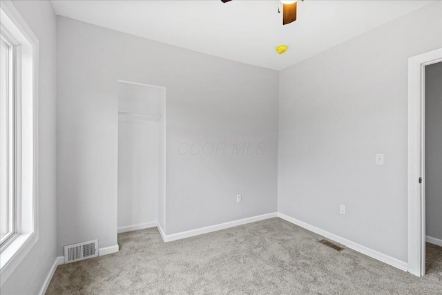 carpeted empty room with ceiling fan